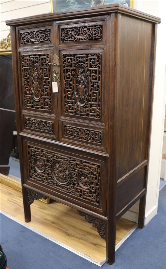 A Chinese carved and pierced hardwood cabinet. W.99cm.